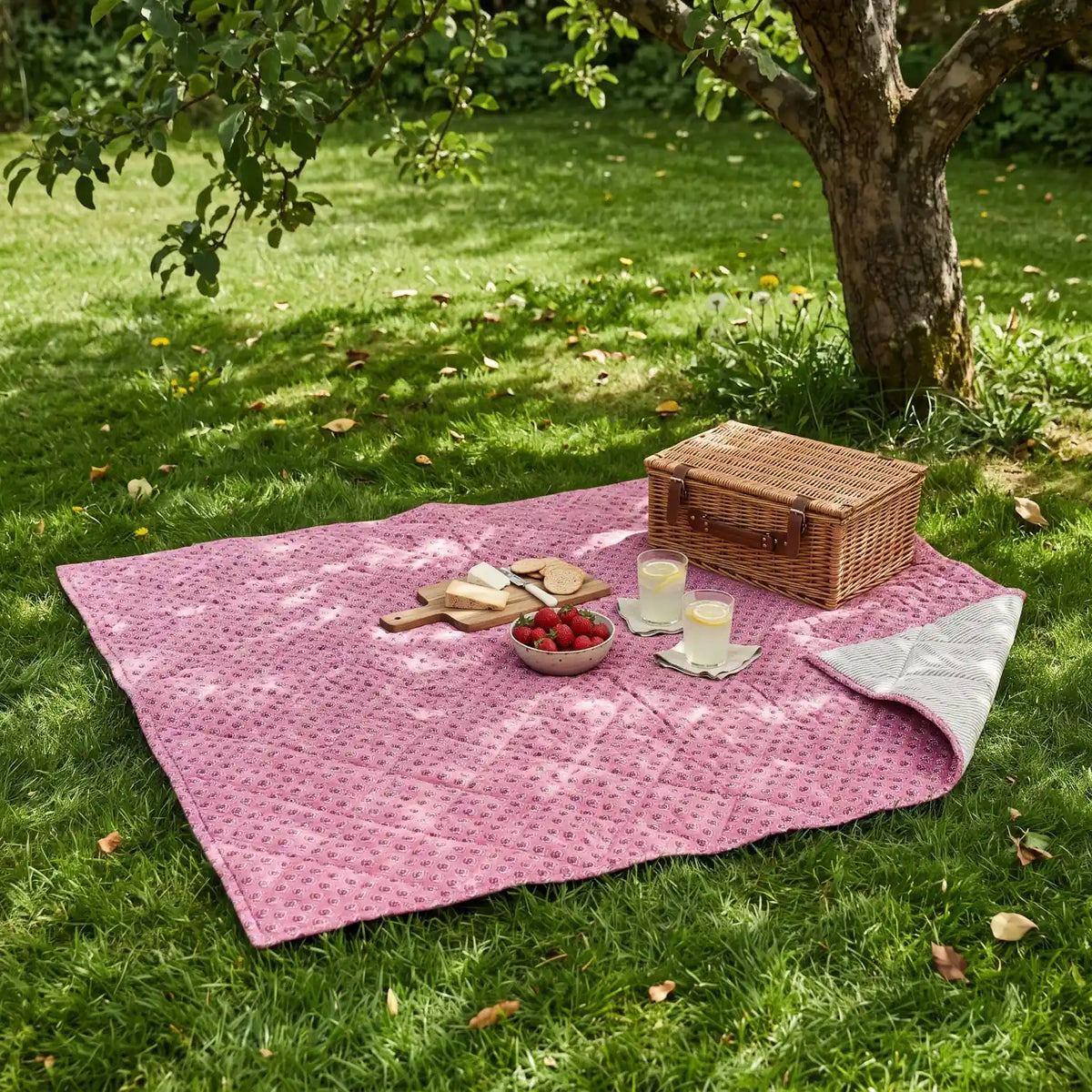 Picnic Blanket 130 x 170 cm spread on a lawn with a picnic basket and strawberries
